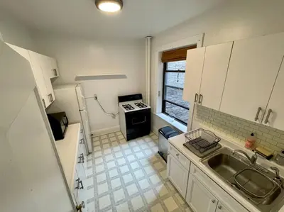 a small kitchen with a sink and a stove at Fantastic stay for 4 – Heart of Hoboken! in Hoboken