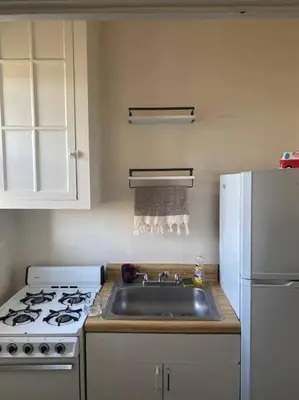 a kitchen with a sink and a stove and a refrigerator at Comfy stay – sleeps 4 (Hoboken) in Hoboken