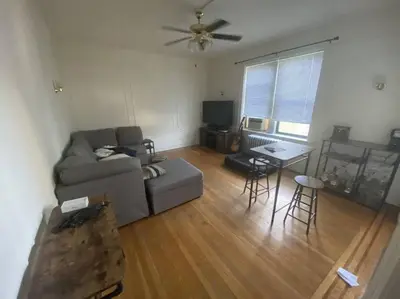 a living room with a couch and a table at Comfy stay – sleeps 4 (Hoboken) in Hoboken
