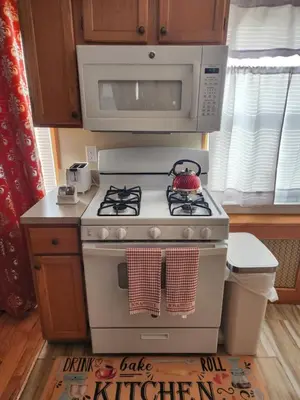a kitchen with a white stove and a microwave at Cozy 2-bedroom Apartment in Philadelphia