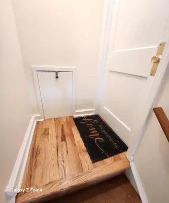 a welcome mat on a wooden floor next to a door at Cozy 2-bedroom Apartment in Philadelphia