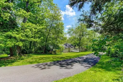 an empty road in a park with trees at Peddlers Carriage house in New Hope