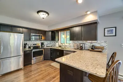 a kitchen with stainless steel appliances and wooden cabinets at Lake Harmony Home Near Big Boulder! in Lake Harmony