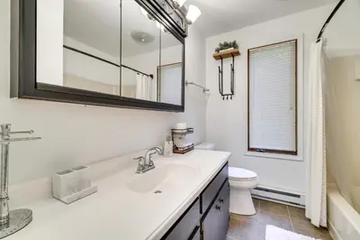 a white bathroom with a sink and a toilet at Lake Harmony Home Near Big Boulder! in Lake Harmony