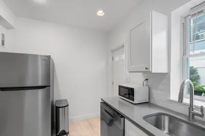 a kitchen with a stainless steel refrigerator and a sink at Luxury 3BR Townhome - Northern Liberty in Philadelphia