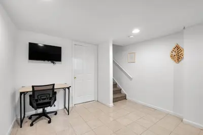 a room with a desk and a tv on a wall at Luxury 3BR Townhome - Northern Liberty in Philadelphia