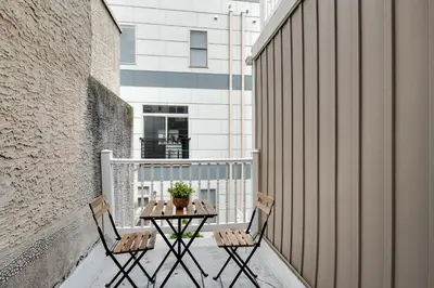 a patio with two chairs and a table on a balcony at Luxury 3BR Townhome - Northern Liberty in Philadelphia