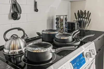 four pots and pans on a stove in a kitchen at Pure Relaxation-Luxury/Roof Top* in Philadelphia