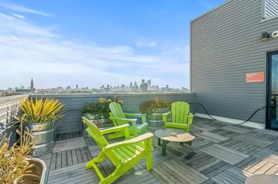 a patio with green chairs and a table on a roof at Pure Relaxation-Luxury/Roof Top* in Philadelphia