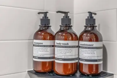 three bottles of honey on a shelf in a refrigerator at Pure Relaxation-Luxury/Roof Top* in Philadelphia