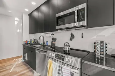 a kitchen with a stainless steel stove and a microwave at Pure Relaxation-Luxury/Roof Top* in Philadelphia