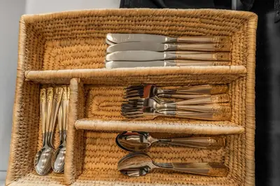 a basket with forks and spoons and utensils at Pure Relaxation-Luxury/Roof Top* in Philadelphia