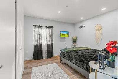 a bedroom with a bed and a table with flowers on it at Pure Relaxation-Luxury/Roof Top* in Philadelphia