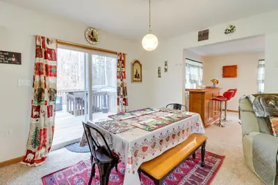 a living room with a table and a kitchen at Less Than 1 Mi to Ski Hill! Poconos Retreat with Game Room in Pocono Lake