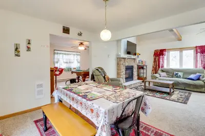 a living room with a table and a fireplace at Less Than 1 Mi to Ski Hill! Poconos Retreat with Game Room in Pocono Lake