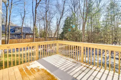 a wooden deck with a bench on a fence at 3 Mi to Kalahari Pocono Summit Home with Pool Table in Pocono Summit