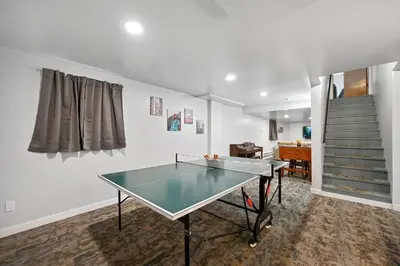 a ping pong table in a room with a staircase at Poconos Peaceful Retreat - Families & Large Groups in Tobyhanna