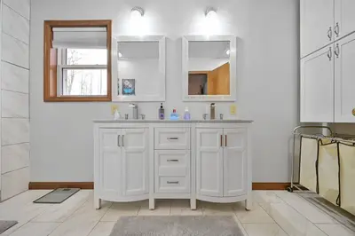 a white bathroom with a sink and a mirror at Poconos Peaceful Retreat - Families & Large Groups in Tobyhanna