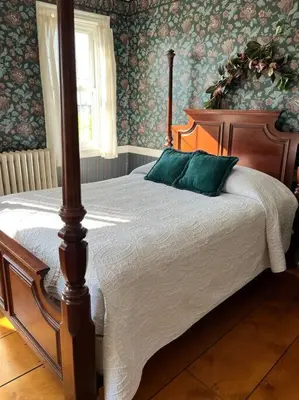 a bedroom with a wooden bed with green pillows at Farmhouse at Landyshade in Lancaster