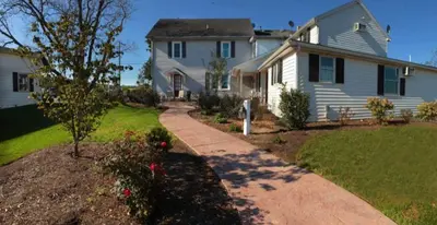 a house with a driveway leading into a yard at Farmhouse at Landyshade in Lancaster