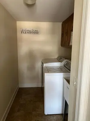 a small kitchen with a refrigerator and a dishwasher at Farmhouse at Landyshade in Lancaster