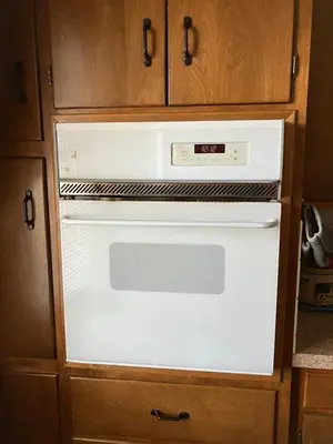 a white oven in a kitchen with wooden cabinets at Farmhouse at Landyshade in Lancaster