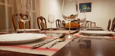 a table with plates and wine glasses on it at Spacious Gateway, Walk to POOL & BEACH, Hot tub, Game room in Pocono Country Place