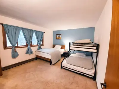a bedroom with two bunk beds and a window at Spacious Gateway, Walk to POOL & BEACH, Hot tub, Game room in Pocono Country Place