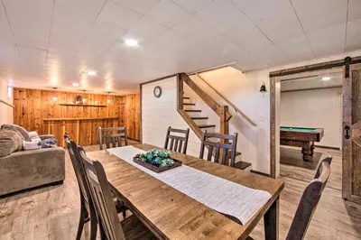 a dining room and living room with a table and chairs at Marietta Home with Private Hot Tub, Pool Table! in Marietta