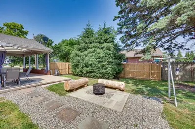 a backyard with a fire pit and a fence at Marietta Home with Private Hot Tub, Pool Table! in Marietta