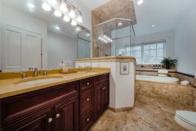 a bathroom with two sinks and a tub and a toilet at The Stone House on Main Street in Stockton