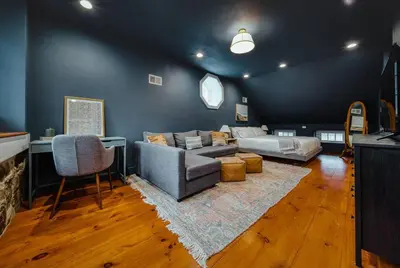 a living room with a couch and a bed at The Stone House on Main Street in Stockton
