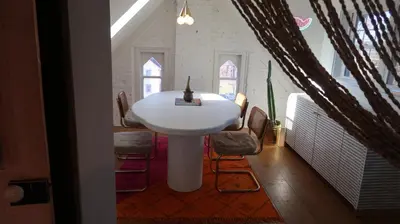 a white table in a room with chairs and a sink at Creative Private Attic 1br Suite in Honey Brook
