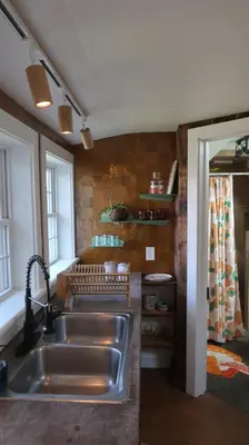 a kitchen with a stainless steel sink and a window at Creative Private Attic 1br Suite in Honey Brook