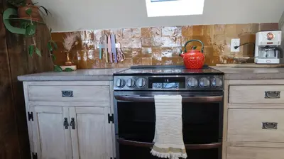 a kitchen with a stove with a towel on it at Creative Private Attic 1br Suite in Honey Brook