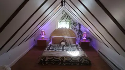 a bedroom with a bed with a teddy bear on it at Creative Private Attic 1br Suite in Honey Brook