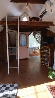 a room with a bunk bed and a living room at Creative Private Attic 1br Suite in Honey Brook