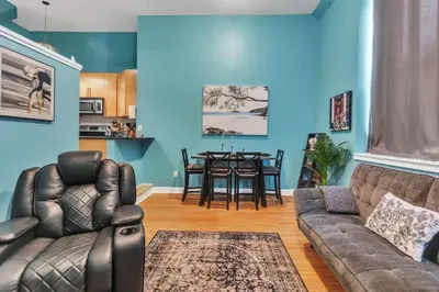 a living room with a couch and a table at Broad Street Apartment in Philadelphia