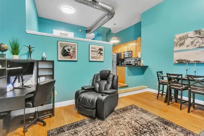 a living room with blue walls and a table and chairs at Broad Street Apartment in Philadelphia