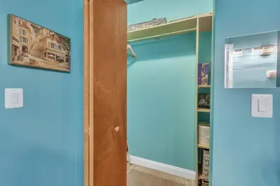 a bedroom with blue walls and a closet at Broad Street Apartment in Philadelphia