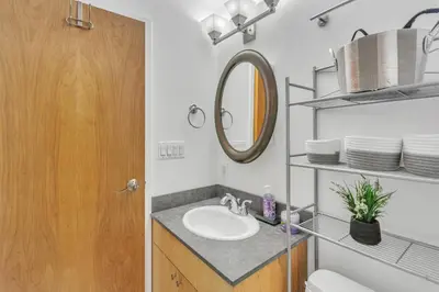 a bathroom with a sink and a mirror at Broad Street Apartment in Philadelphia