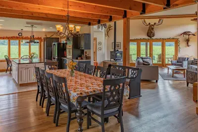 a dining room and kitchen with a table and chairs at Tenwood Lodge in Ithaca