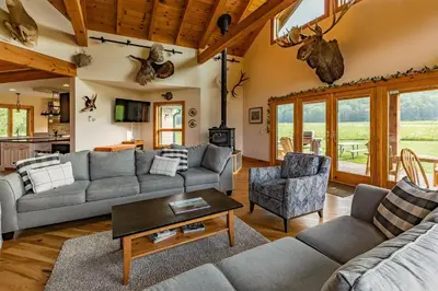 a living room with a couch and a table at Tenwood Lodge in Ithaca