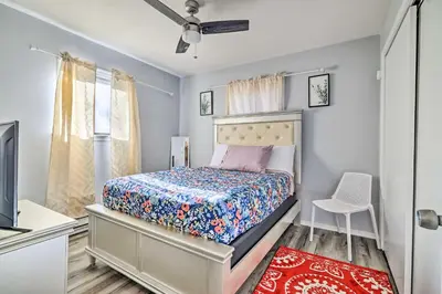 a bedroom with a bed and a chair in it at Tobyhanna Home Near Kalahari with Lake and Pool Access in Tobyhanna
