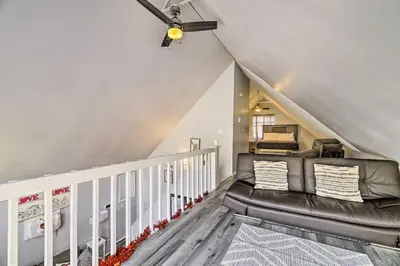 a living room with a couch in the attic at Tobyhanna Home Near Kalahari with Lake and Pool Access in Tobyhanna