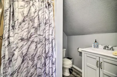a bathroom with a marble shower curtain next to a toilet at Tobyhanna Home Near Kalahari with Lake and Pool Access in Tobyhanna