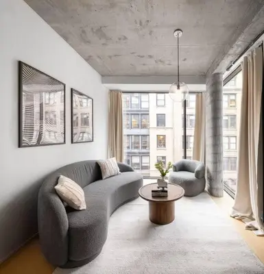 a living room with a couch and two chairs and a table at Stunning Penthouse in Chelsea in New York