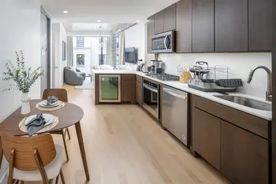 a kitchen with a table and a counter top at Stunning Penthouse in Chelsea in New York