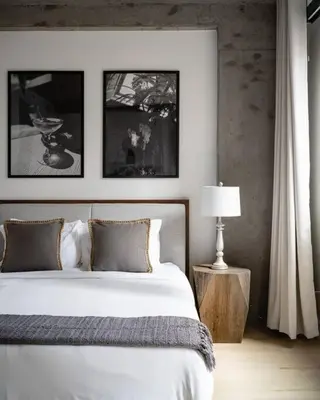 a bedroom with a bed and a table with a lamp at Stunning Penthouse in Chelsea in New York