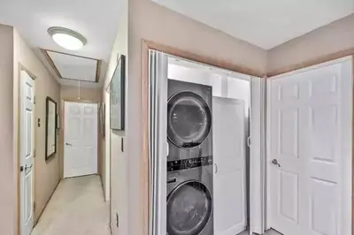 a hallway with two washing machines in a house at Cheerful 5-bedroom resort with heated pool in East Stroudsburg